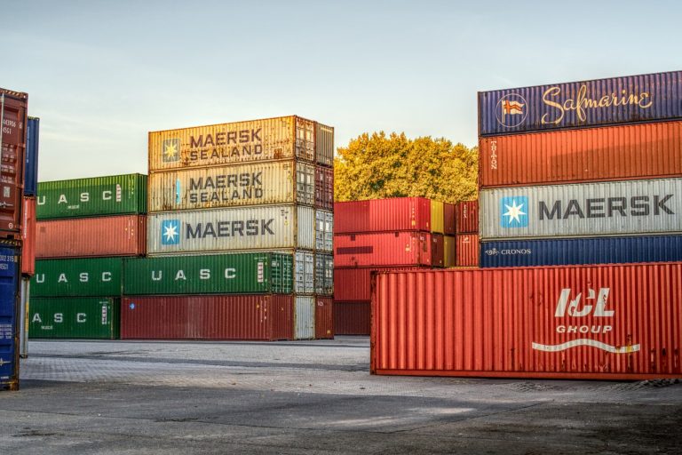 Multiple stacked cargo bins sitting outside for Inland Marine Insurance.