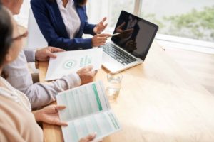 older couple looking over a life insurance policy with an insurance agent