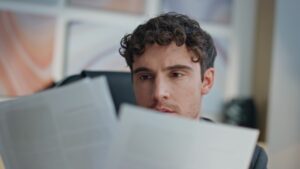 man looking at documents for named insured vs additional insured